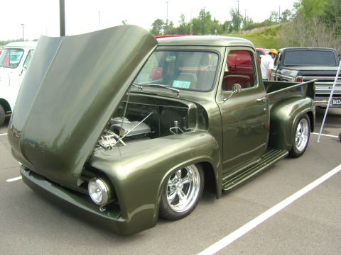 2007 Ford Mustang - This custom 1956 Ford F-series pickup truck features a metallic green paint job and exposed engine under the raised hood.