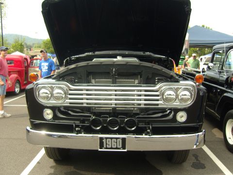 2007 Ford Mustang - A black 1960 Ford F-Series truck is displayed with its hood open at an outdoor event.