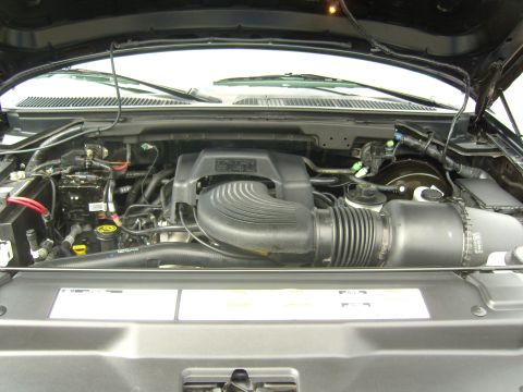 2007 Ford Mustang - The engine compartment of a Ford F-150 truck, showing the V8 engine and associated components.