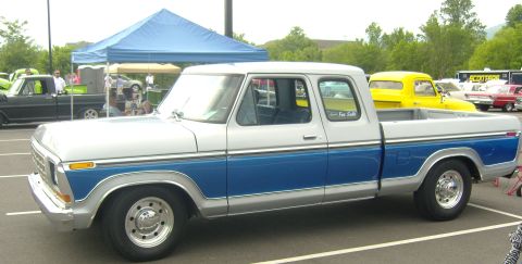 2007 Ford Mustang - A classic pickup truck is parked at an outdoor event with other vehicles visible.