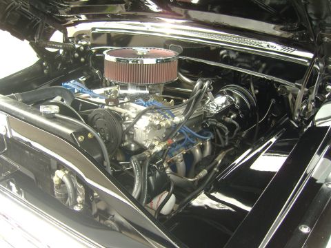 2007 Ford Mustang - Close-up view of a polished engine bay a V8 engine with chrome accents and blue spark plug wires.