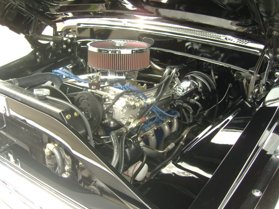 engine bay with chrome air cleaner, V8 engine, and blue spark plug wires