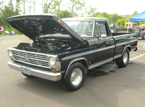2007 Ford Mustang - A black 1967 Ford F-100 pickup truck is displayed with its hood open at an outdoor event.