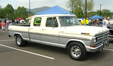 2007 Ford Mustang - A two-tone white and silver crew cab pickup truck is parked at an outdoor event.