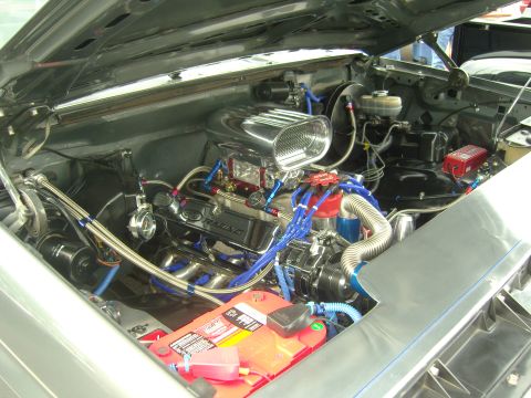 2007 Ford Mustang - The engine bay of a vehicle is shown with various components and custom modifications visible.