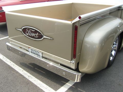 2007 Ford Mustang - Close-up of the rear of a classic Ford pickup truck, a chrome bumper and a prominent Ford emblem on the tailgate.