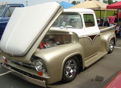 2007 Ford Mustang - A customized 1956 Ford F-series truck is displayed with its hood open at an outdoor event.