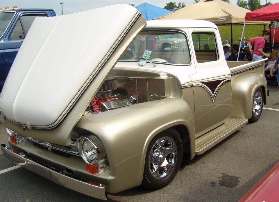 Gold and white 1956 Ford F-series truck with hood open, showing engine. Chrome wheels and trim