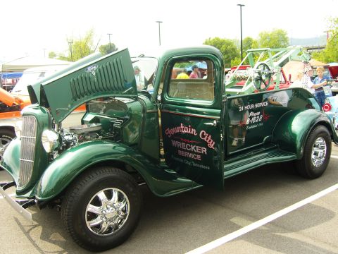 2007 Ford Mustang - This vintage Ford wrecker truck has "Fountain City Wrecker Service" painted on its door and "24 Hour Service" on the bed.