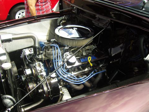2007 Ford Mustang - Detailed view of a polished Ford V8 engine, chrome accents and blue ignition wires.
