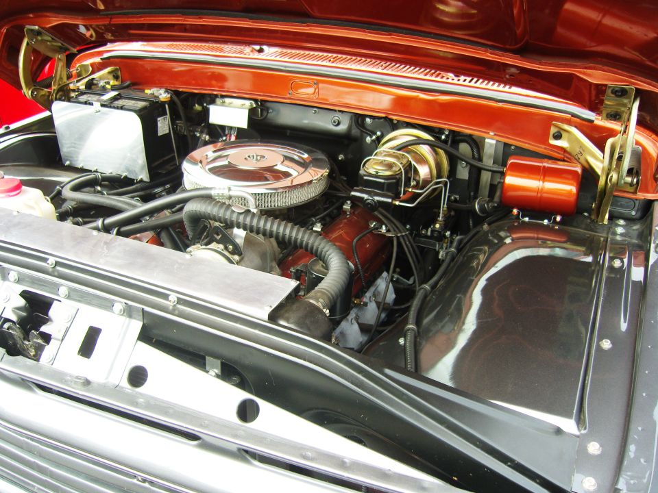 Engine bay with chrome air cleaner, brake booster, and orange painted components