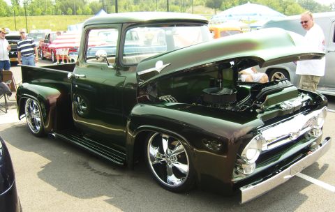2007 Ford Mustang - A customized 1956 Ford F-100 pickup truck is displayed with its hood open, its engine and chrome accents.
