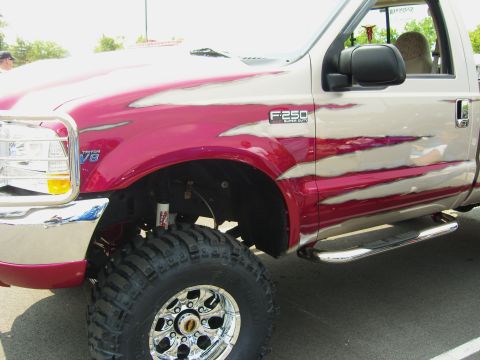 2007 Ford Mustang - This lifted Ford F-250 Super Duty features a custom flame paint job and large off-road tires.