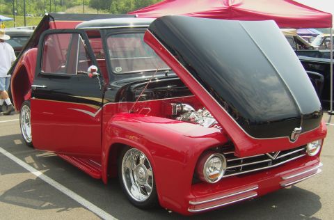 2007 Ford Mustang - A two-tone red and black custom pickup truck is displayed with its hood and doors open.