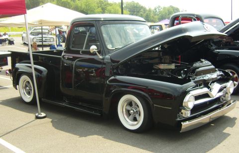 2007 Ford Mustang - This black 1956 Ford F-series pickup truck is displayed with its hood open at an outdoor event.