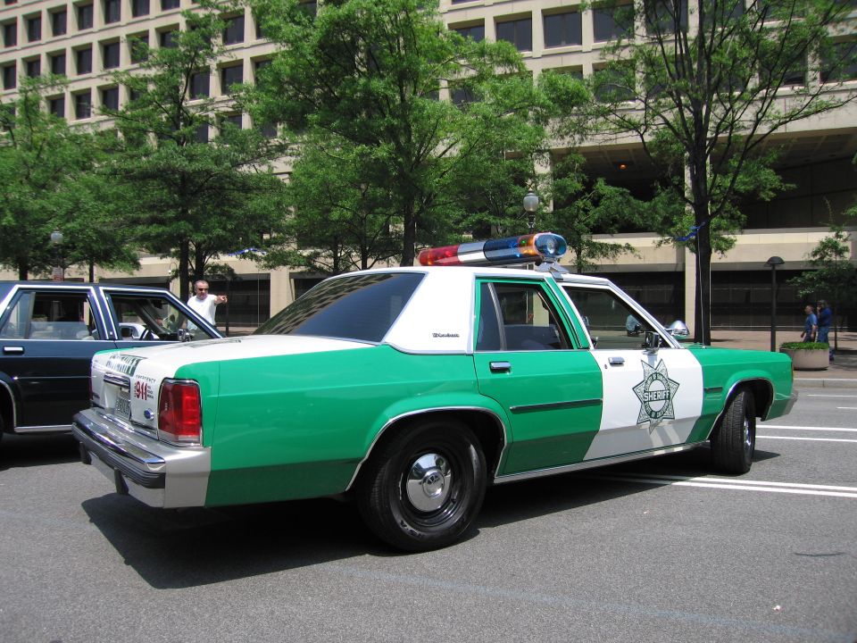Green and white Sheriff Ford LTD Crown Victoria rear quarter view