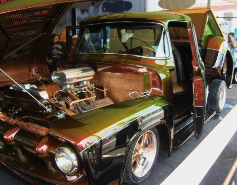 2007 Ford Mustang - A heavily modified 1956 Ford F-100 pickup truck is displayed with its hood and doors open, revealing a custom engine and interior.