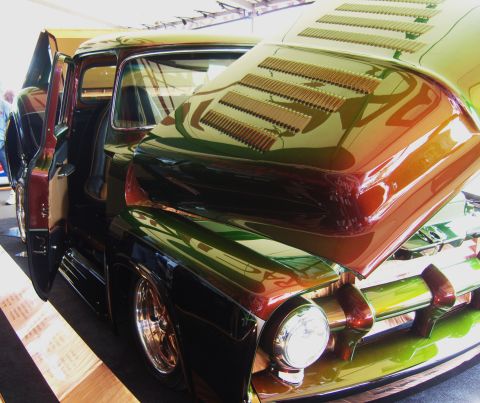 2007 Ford Mustang - Customized pickup truck with hood open, a unique multi-color paint job and louvers on the hood.