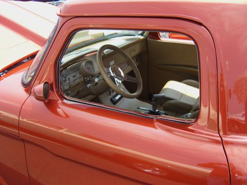 2007 Ford Mustang - View through the window of a custom pickup truck's interior, highlighting the steering wheel and dashboard.