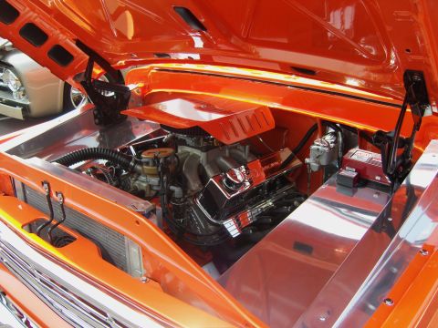 2007 Ford Mustang - The engine bay of a custom car is shown with a V8 engine and polished metal accents.