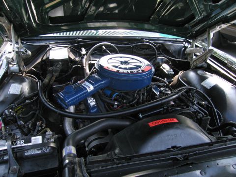 1991 Ford Crown Victoria - Engine bay view showing the air cleaner, hoses, and battery.