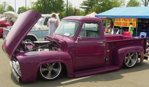 2007 Ford Mustang - A custom purple pickup truck is displayed with its hood open at an outdoor event.