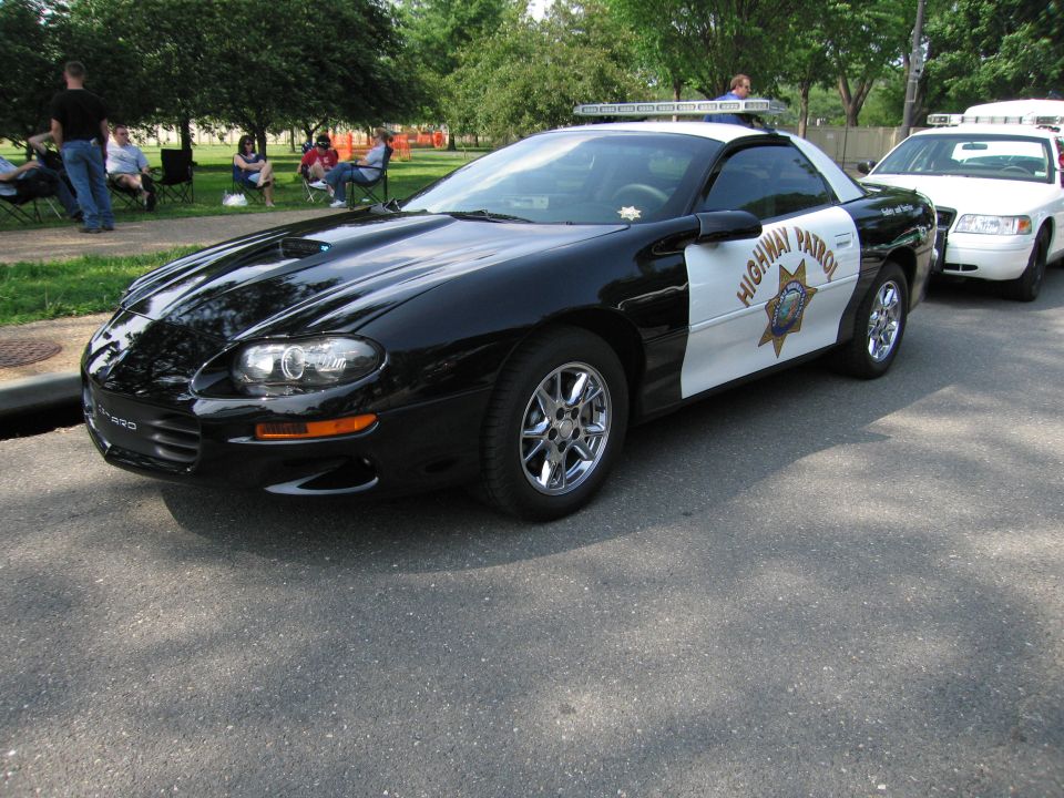 Black-and-white Chevrolet Camaro Highway Patrol car with lightbar