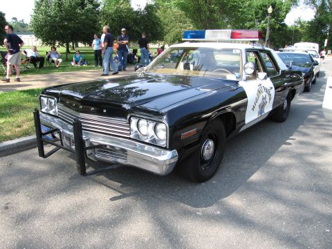 1991 Ford Crown Victoria - This 1977 Dodge Monaco police car is on display with other vehicles.