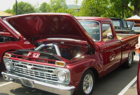 2007 Ford Mustang - A red 1964 Ford pickup truck is displayed with its hood open, revealing the engine compartment.