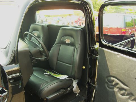2007 Ford Mustang - Interior of a classic truck with custom leather seats and an embossed Ford logo on the door panel.