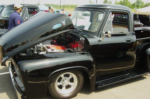 2007 Ford Mustang - A black Ford F-series truck is displayed with its hood open, revealing the V8 engine and Ford badging.