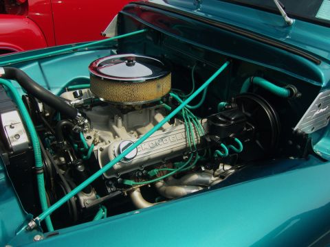 2007 Ford Mustang - Engine bay of a teal vehicle, a chrome air cleaner and a valve cover with 'HONDELL' visible.
