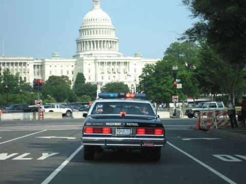 1991 Ford Crown Victoria - Chevrolet Caprice police car with 'HIGHWAY PATROL' text on the rear, parked near the US Capitol.