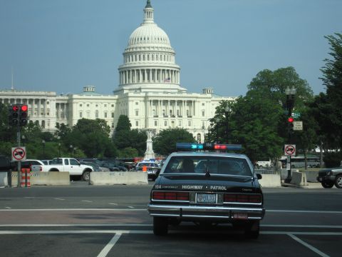 1991 Ford Crown Victoria - A police car is parked in front of the US Capitol building.