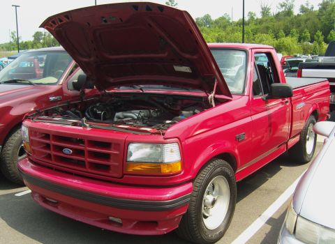 2007 Ford Mustang - This red Ford F-150 pickup truck, likely from the mid-1990s, is displayed with its hood open at an outdoor gathering.