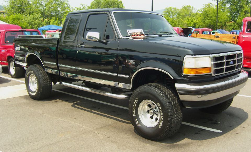 Black Ford F-150 pickup truck with chrome trim and aftermarket wheels