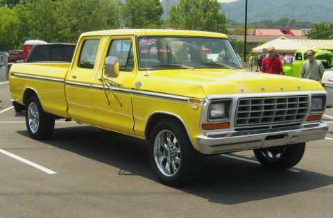 2007 Ford Mustang - Front three-quarter view of a yellow late-1970s Ford crew cab long-bed pickup with chrome bumpers, egg-crate grille and polished aftermarke…