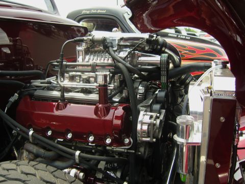 2007 Ford Mustang - Custom V8 engine with supercharger and chrome details, parked next to a car with flame graphics.