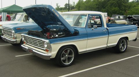 2007 Ford Mustang - Classic Ford F-100 pickup trucks displayed at an outdoor event.