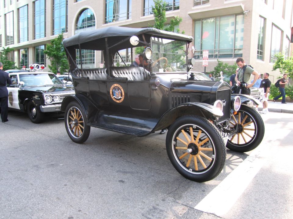 Black vintage Ford Model T open touring car with police seal on door