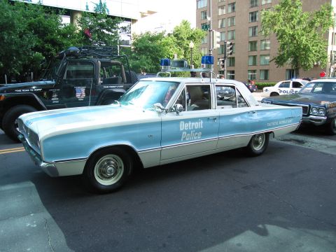 1991 Ford Crown Victoria - A vintage Detroit Police car, likely a 1966 Dodge Polara, is parked on a city street.