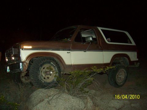 1985 Ford Bronco - This 1980s Ford Bronco 4x4 is seen off-road at night, with a "4x4" badge on the side.