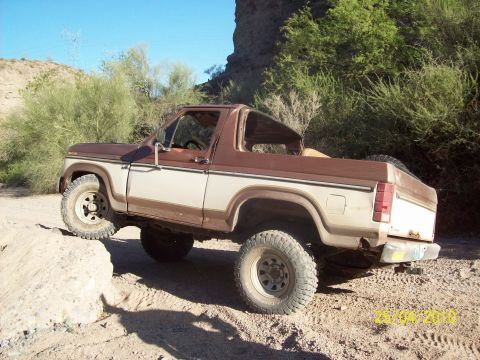1985 Ford Bronco - This 1985 Ford Bronco is shown navigating rough terrain off-road.