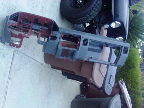1986 Ford Bronco - A disassembled dashboard assembly is laid out, showing its internal components and structure.