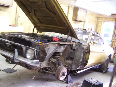 1972 Ford Mustang - This 1972 Ford Mustang is undergoing a tear down, with the front end disassembled and hood open.