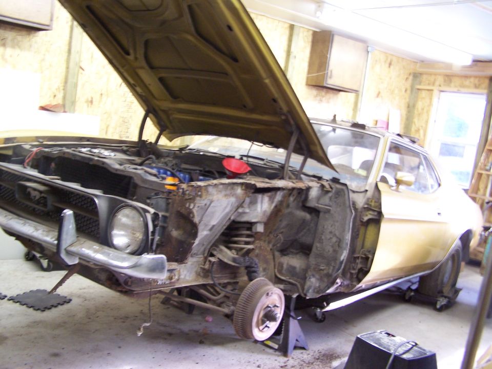1972 Ford Mustang with hood open, front end disassembled, sitting on jack stands