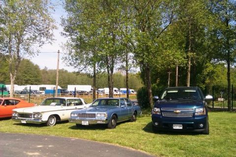 1991 Ford LTD Crown Victoria - A blue sedan is parked on a grassy area with trees in the background.