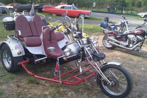 1991 Ford LTD Crown Victoria - A custom trike with two seats and a Confederate flag is parked outdoors with other vehicles.