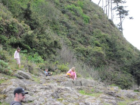 1996 Ford Bronco - Children explore a rocky area with dense green foliage covering the hillside above them.