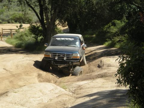 1994 Ford Bronco - This 1994 Ford Bronco is tackling an off-road trail with significant suspension articulation.